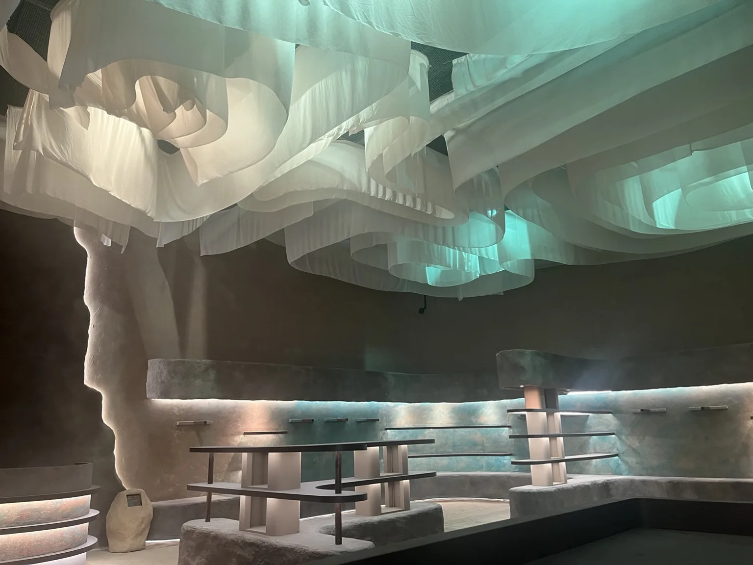 Themed interior with a sculptural suspended ceiling and integrated scenic lighting.